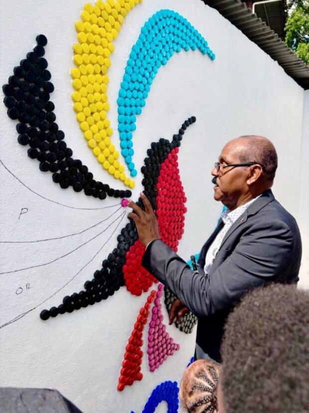 PM Browne Joins Villa Primary Students to Build CHOGM 2026 Bottle Cap Mural